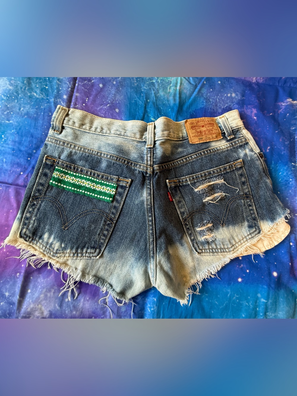 Levi's Distressed Blue Denim Cutoff Shorts with Green Embellished Pocket